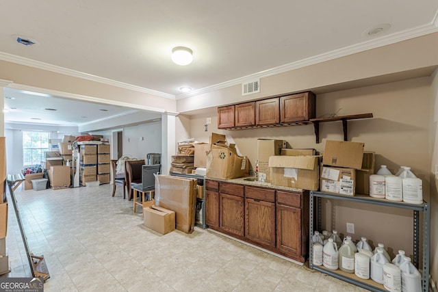 118 Surge Stone Ln, Stockbridge, GA 30281 - kitchen with brown cabinetry, ornamental molding, light flooring, and open floor plan