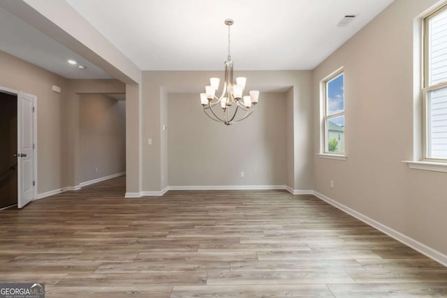 4000 Red Canoe Bnd, Lilburn, GA 30047 - empty room with a chandelier, light wood finished floors, and baseboards