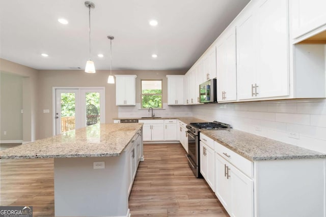 4000 Red Canoe Bnd, Lilburn, GA 30047 - kitchen featuring stainless steel appliances, a sink, a kitchen island, tasteful backsplash, and recessed lighting