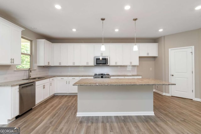 4000 Red Canoe Bnd, Lilburn, GA 30047 - kitchen featuring stainless steel appliances, a sink, a center island, backsplash, and recessed lighting