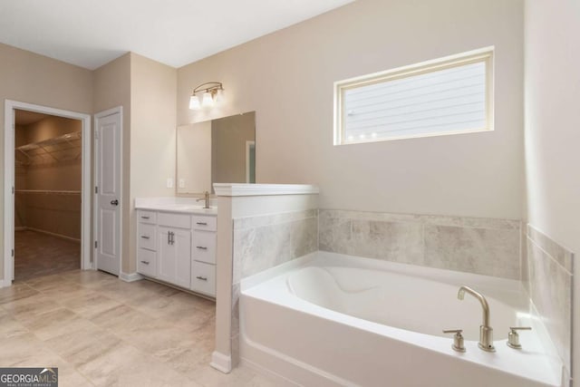 4000 Red Canoe Bnd, Lilburn, GA 30047 - bathroom with vanity, a bath, and a spacious closet