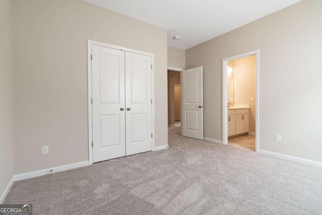 4000 Red Canoe Bnd, Lilburn, GA 30047 - unfurnished bedroom featuring light carpet, a closet, ensuite bath, and baseboards