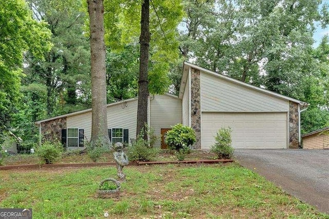 3902 Cedarwoods Way, Lawrenceville, GA 30044 - view of front facade with driveway, stone siding, and a garage