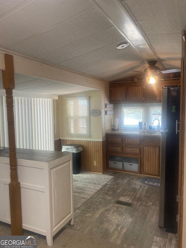 32 Yogi Bear Blvd, Cleveland, GA 30528 - kitchen with freestanding refrigerator, hardwood / wood-style flooring, a sink, wooden walls, and wainscoting