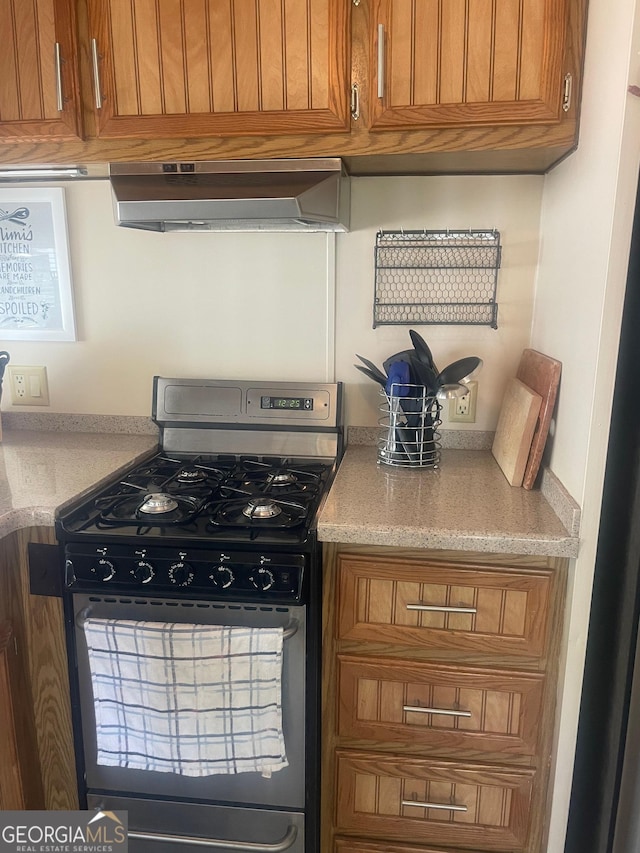 32 Yogi Bear Blvd, Cleveland, GA 30528 - kitchen featuring stainless steel range with gas cooktop, ventilation hood, brown cabinets, and light stone countertops