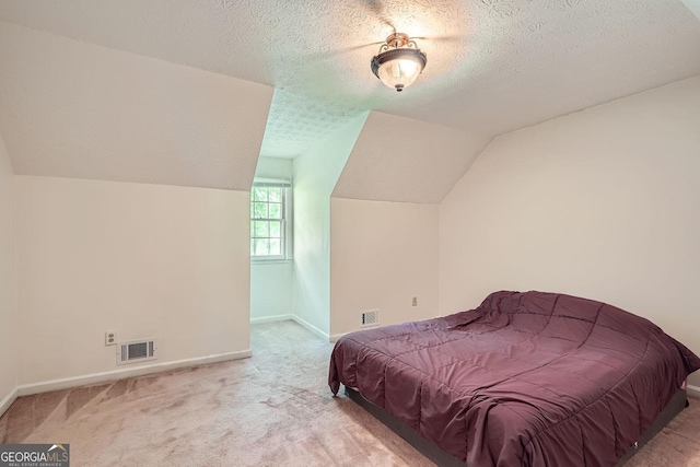 1739 Brandy Woods Trl SE, Conyers, GA 30013 - carpeted bedroom with lofted ceiling, a textured ceiling, and baseboards