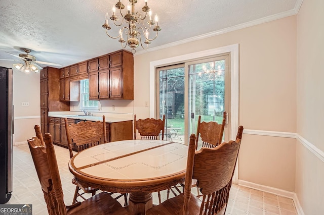 1739 Brandy Woods Trl SE, Conyers, GA 30013 - dining area with a textured ceiling, baseboards, a chandelier, a ceiling fan, and crown molding