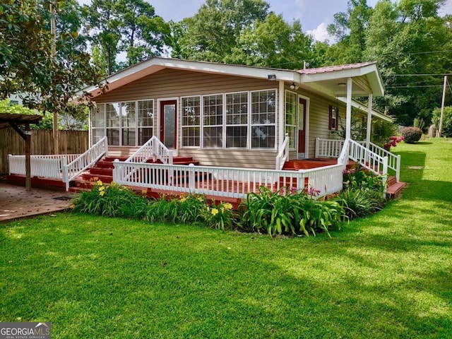198 Swift Creek Rd, Cordele, GA 31015 - back of house featuring a wooden deck and a sunroom