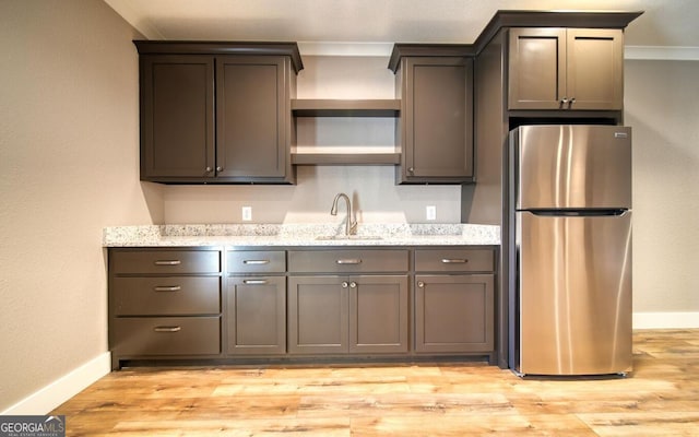 2628 Rolling River Dr, Hiawassee, GA 30546 - kitchen featuring freestanding refrigerator, a sink, open shelves, baseboards, and light wood finished floors