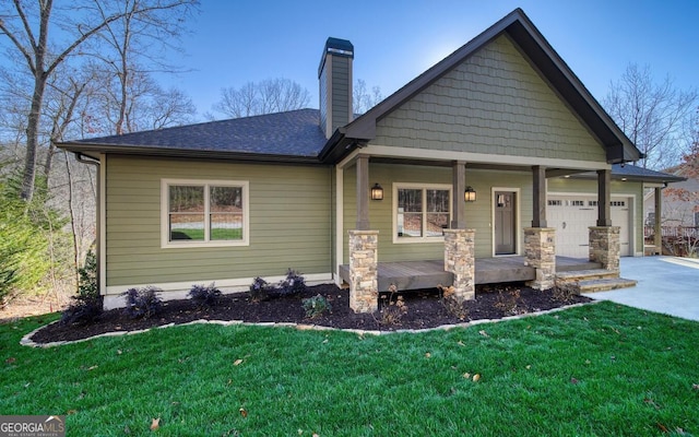 2628 Rolling River Dr, Hiawassee, GA 30546 - craftsman inspired home with a porch, concrete driveway, a garage, and a front lawn