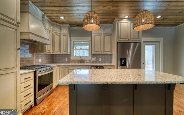 2628 Rolling River Dr, Hiawassee, GA 30546 - kitchen featuring stainless steel appliances, a sink, wall chimney range hood, light wood-type flooring, and a kitchen breakfast bar