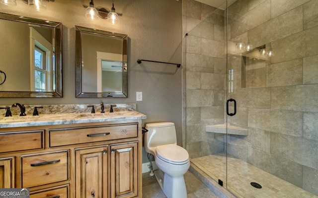 2628 Rolling River Dr, Hiawassee, GA 30546 - bathroom featuring double vanity, a shower stall, toilet, and a textured wall