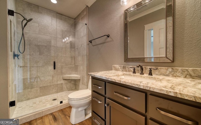2628 Rolling River Dr, Hiawassee, GA 30546 - bathroom with a textured wall, vanity, wood finished floors, a shower stall, and toilet