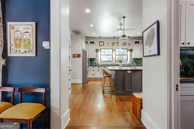 781 Boulevard, Athens, GA 30601 - kitchen with freestanding refrigerator, ceiling fan, a sink, decorative backsplash, and light wood-style floors