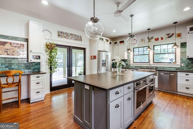 781 Boulevard, Athens, GA 30601 - kitchen featuring appliances with stainless steel finishes, decorative backsplash, a sink, hardwood / wood-style flooring, and recessed lighting