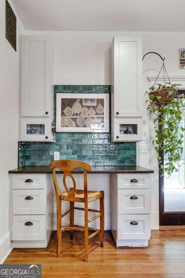 781 Boulevard, Athens, GA 30601 - kitchen with white cabinets, tasteful backsplash, light wood finished floors, and dark stone counters