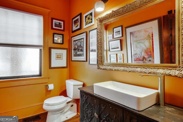 781 Boulevard, Athens, GA 30601 - half bathroom with toilet, vanity, baseboards, and wood finished floors