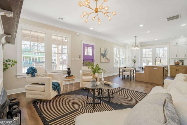 1253 Lucile Ave SW, Atlanta, GA 30310 - living room with a chandelier, dark wood-style floors, baseboards, crown molding, and recessed lighting