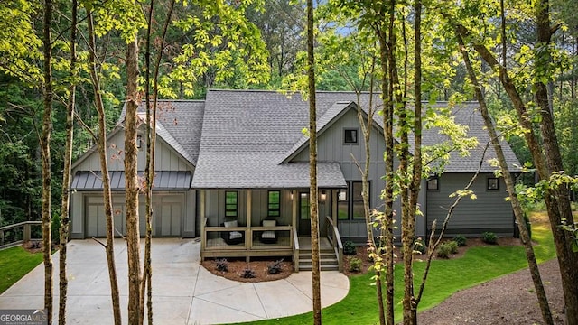 980 Bridge Rd, Ellijay, GA 30540 - view of front of house with roof with shingles, a porch, board and batten siding, concrete driveway, and a garage
