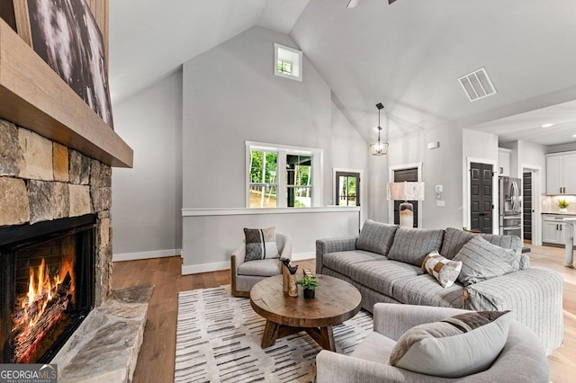980 Bridge Rd, Ellijay, GA 30540 - living room with a fireplace, light wood-type flooring, high vaulted ceiling, plenty of natural light, and recessed lighting