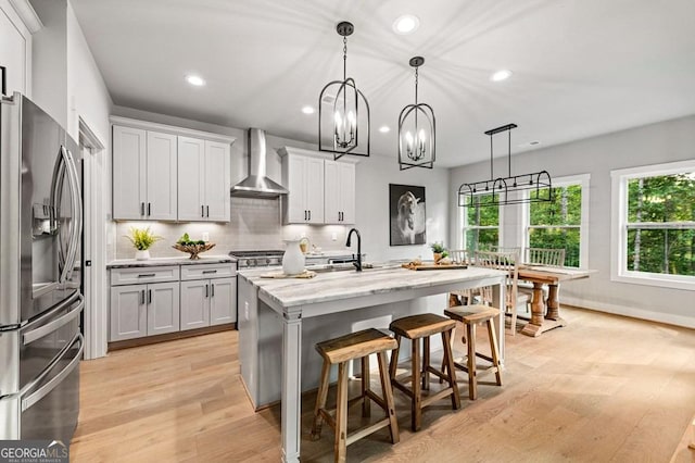 980 Bridge Rd, Ellijay, GA 30540 - kitchen featuring stainless steel fridge, wall chimney range hood, recessed lighting, light wood-type flooring, and healthy amount of natural light