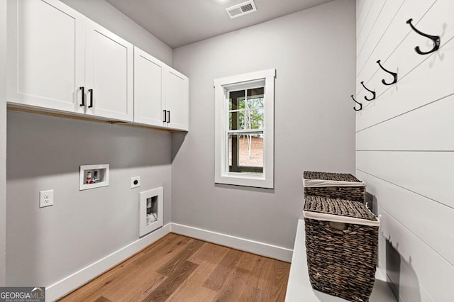 980 Bridge Rd, Ellijay, GA 30540 - laundry area with cabinet space, electric dryer hookup, light wood-type flooring, and hookup for a washing machine