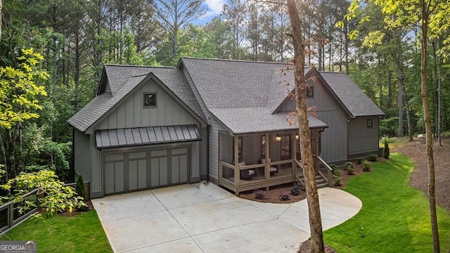 980 Bridge Rd, Ellijay, GA 30540 - view of front facade featuring a shingled roof, board and batten siding, a front lawn, driveway, and a garage