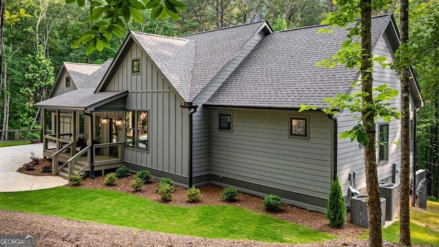 980 Bridge Rd, Ellijay, GA 30540 - view of front of house with a shingled roof, board and batten siding, a front lawn, and driveway