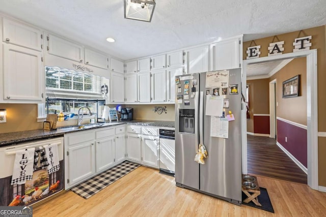 2019 Wiltshire Pl, Snellville, GA 30078 - kitchen with stainless steel refrigerator with ice dispenser, light wood-style floors, white cabinets, dishwashing machine, and dark stone countertops