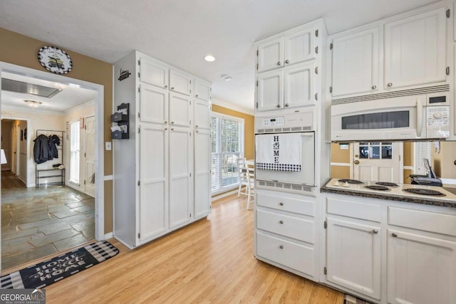 2019 Wiltshire Pl, Snellville, GA 30078 - kitchen with white appliances, white cabinets, crown molding, recessed lighting, and light wood-type flooring