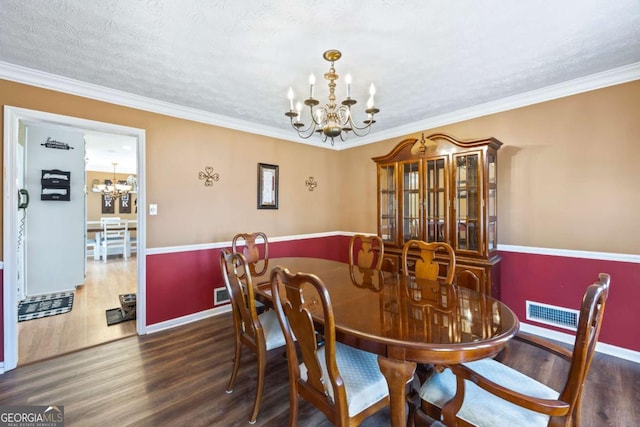 2019 Wiltshire Pl, Snellville, GA 30078 - dining space with a chandelier, wood finished floors, a textured ceiling, and ornamental molding