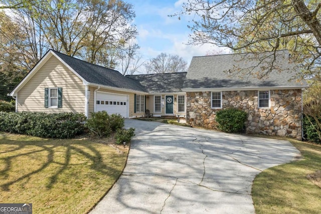 2019 Wiltshire Pl, Snellville, GA 30078 - view of front of house featuring driveway, a garage, a front lawn, and stone siding