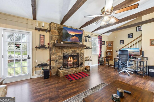 2019 Wiltshire Pl, Snellville, GA 30078 - living area featuring wood finished floors, a ceiling fan, a stone fireplace, a decorative wall, and a desk