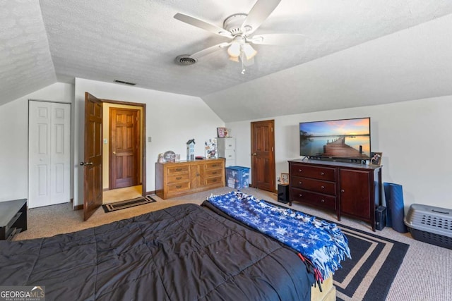 2019 Wiltshire Pl, Snellville, GA 30078 - carpeted bedroom with vaulted ceiling, ceiling fan, and a textured ceiling