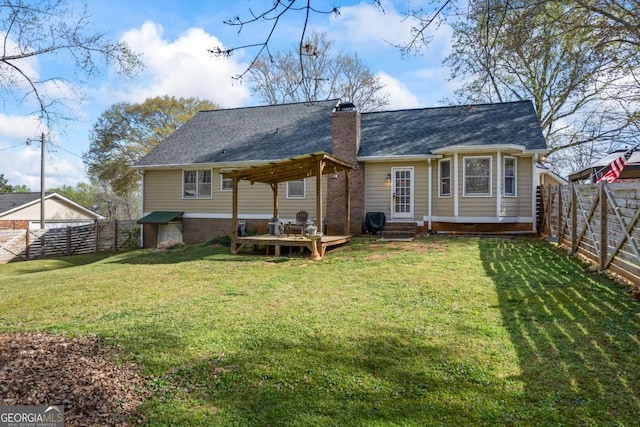 2019 Wiltshire Pl, Snellville, GA 30078 - back of house featuring a fenced backyard, a chimney, a wooden deck, entry steps, and a shingled roof
