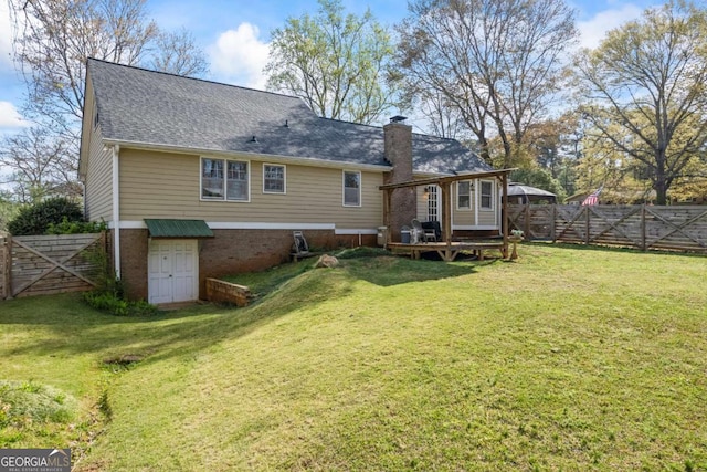 2019 Wiltshire Pl, Snellville, GA 30078 - rear view of property with a fenced backyard, a wooden deck, a chimney, and a gate