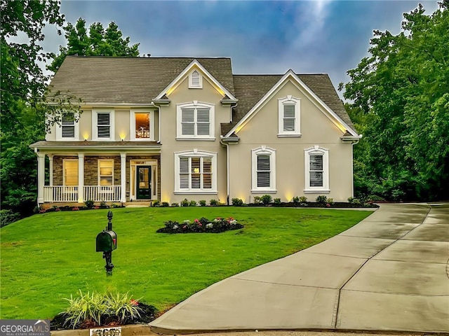 365 Morning Dew Cir, Roswell, GA 30075 - traditional-style house with covered porch, stucco siding, a front lawn, stone siding, and roof with shingles