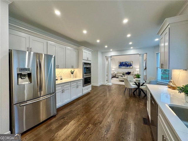 365 Morning Dew Cir, Roswell, GA 30075 - kitchen with stainless steel appliances, decorative columns, open floor plan, dark wood-style flooring, and tasteful backsplash
