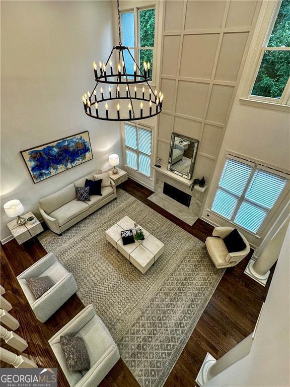 365 Morning Dew Cir, Roswell, GA 30075 - living area with wood finished floors, a chandelier, and plenty of natural light