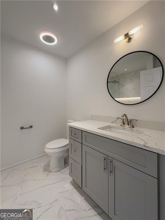 365 Morning Dew Cir, Roswell, GA 30075 - full bath with vanity, marble look tile flooring, and toilet