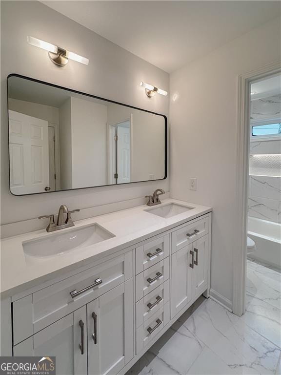 365 Morning Dew Cir, Roswell, GA 30075 - full bathroom with marble look tiles, double vanity, a bathtub, toilet, and baseboards