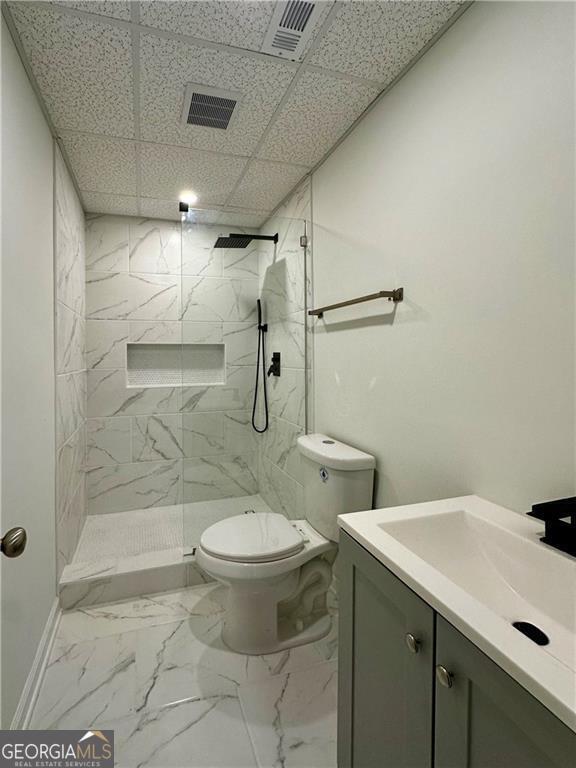 365 Morning Dew Cir, Roswell, GA 30075 - bathroom with vanity, toilet, a marble finish shower, marble finish floors, and a drop ceiling