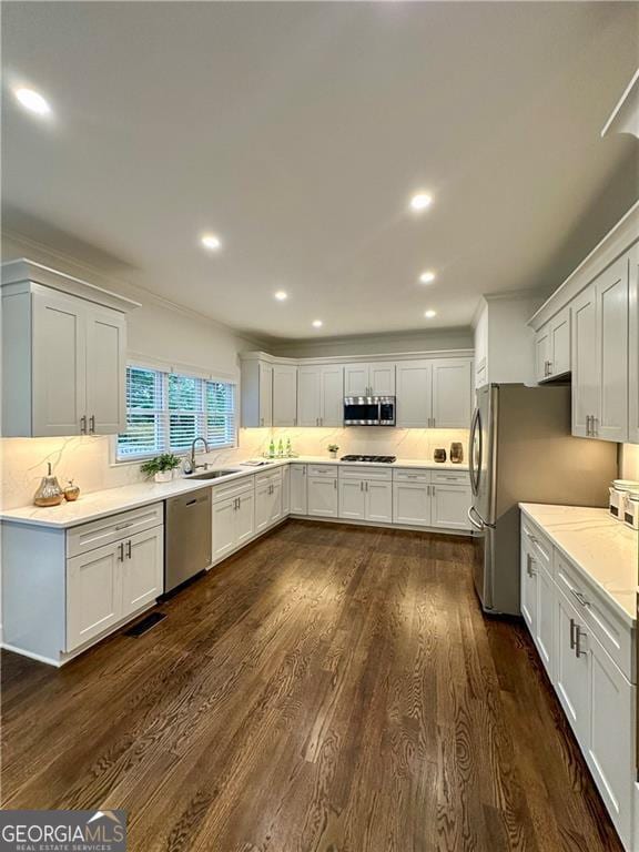 365 Morning Dew Cir, Roswell, GA 30075 - kitchen with stainless steel appliances, a sink, dark wood finished floors, decorative backsplash, and recessed lighting