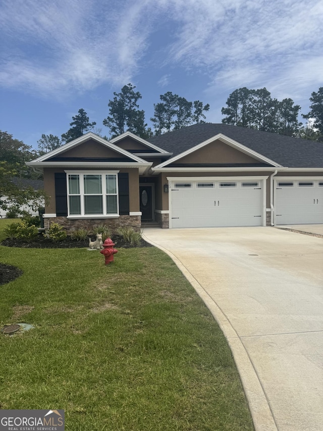 223 Ryan Nicholas Dr, Kingsland, GA 31548 - craftsman-style house featuring stone siding, a garage, driveway, a front yard, and stucco siding