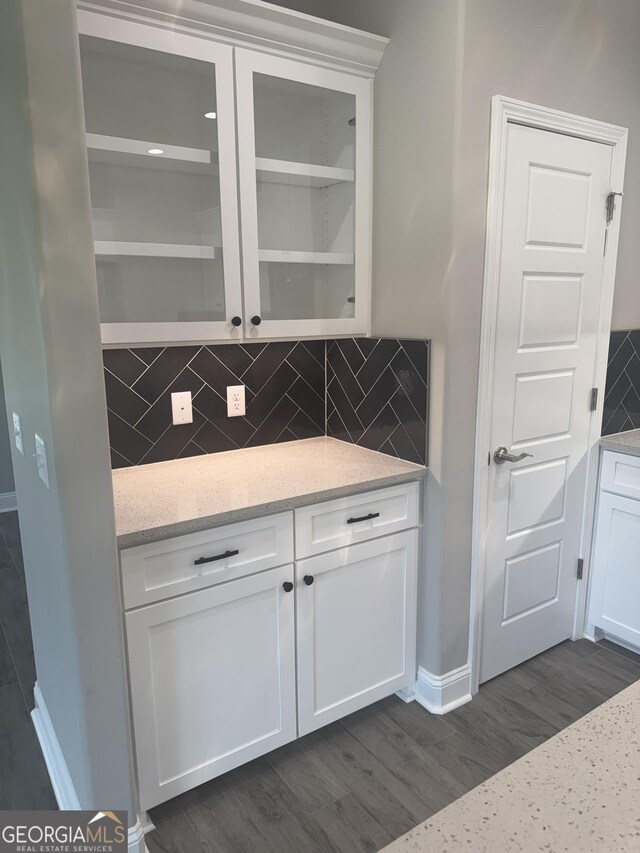 223 Ryan Nicholas Dr, Kingsland, GA 31548 - bar area with decorative backsplash, dark wood-type flooring, and baseboards