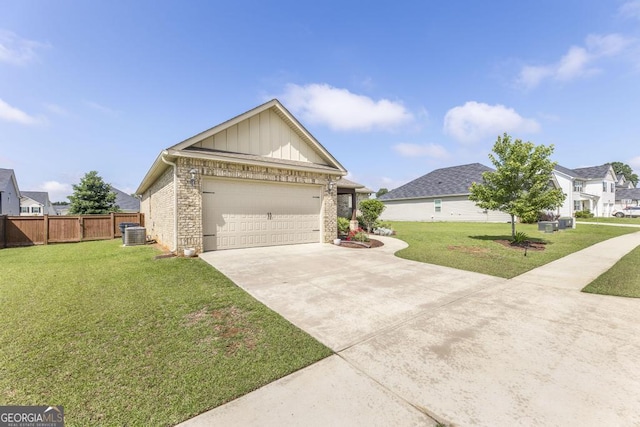 213 Barnyard Way, Perry, GA 31069 - view of front of house with board and batten siding, concrete driveway, brick siding, central air condition unit, and a garage