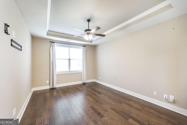 213 Barnyard Way, Perry, GA 31069 - spare room with a raised ceiling, ceiling fan, dark wood-style flooring, ornamental molding, and baseboards