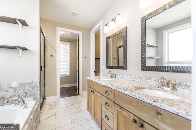 213 Barnyard Way, Perry, GA 31069 - full bathroom featuring marble look tile flooring, plenty of natural light, a stall shower, and double vanity