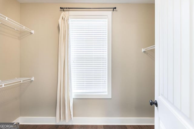 213 Barnyard Way, Perry, GA 31069 - walk in closet with dark wood-style flooring