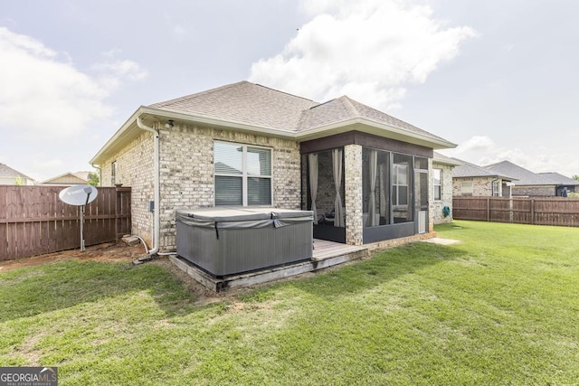 213 Barnyard Way, Perry, GA 31069 - rear view of house featuring a hot tub, a sunroom, and roof with shingles